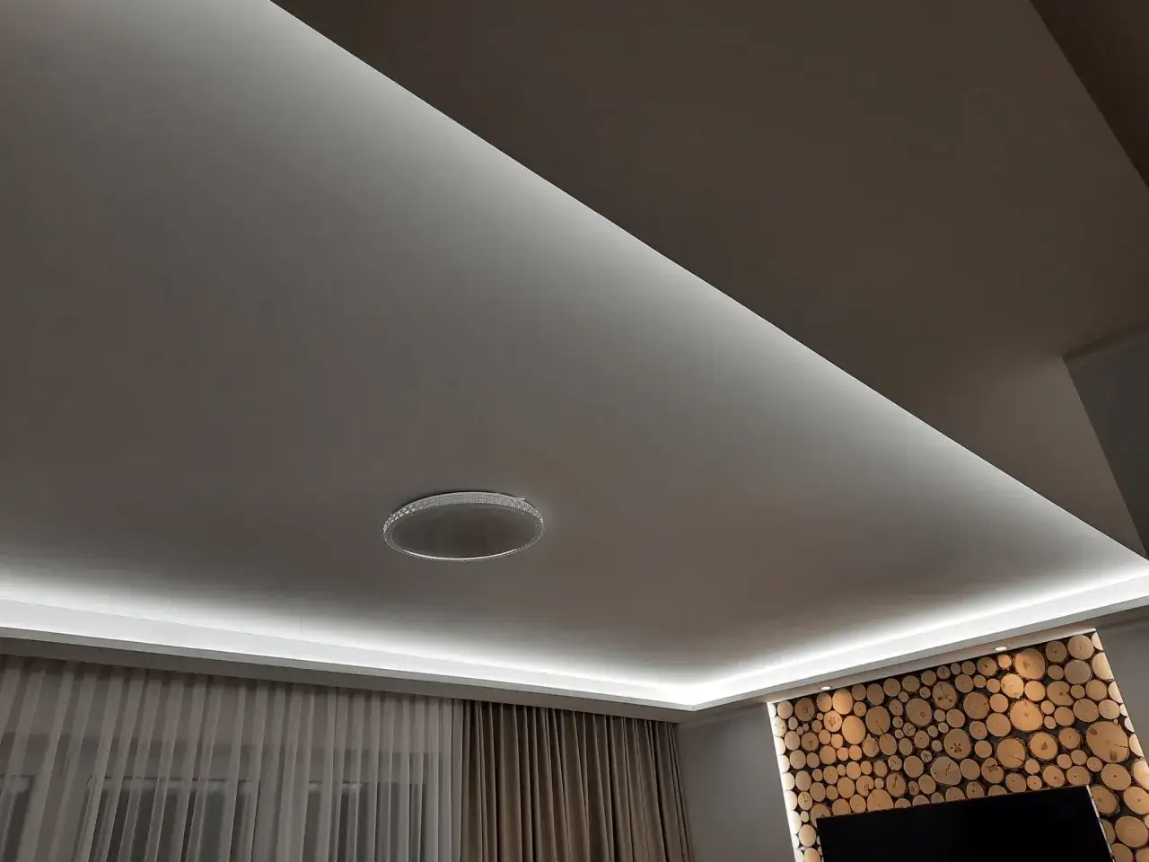 Nowoczesne lampy w suficie podwieszanym tworzą subtelne, rozproszone światło, podkreślając elegancję wnętrza.